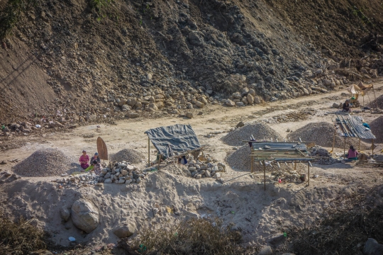 Women hammering stones