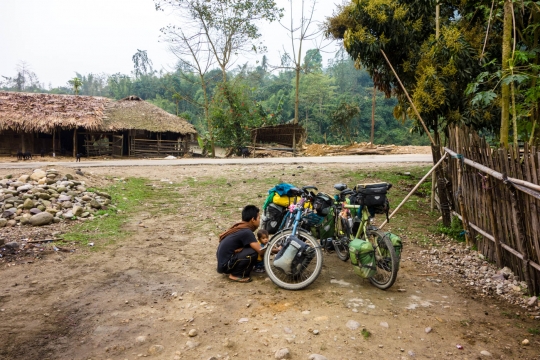 Brother of family inspecting bicycle