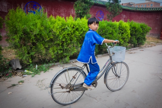 Wushu practising boy on bike