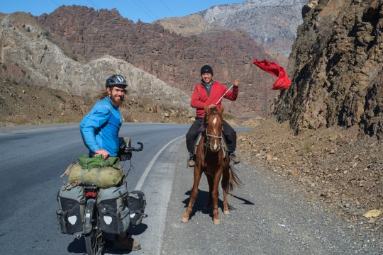Horse rider guiding pack of horses. Photo by Bertrand.