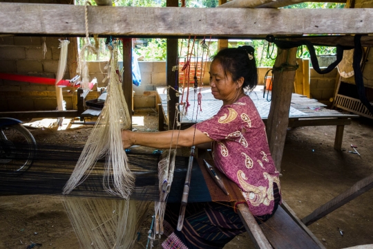 Woman weaving in village