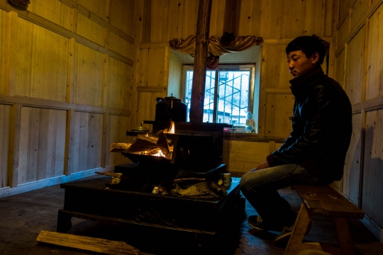 Warming up at the stove in the kitchen