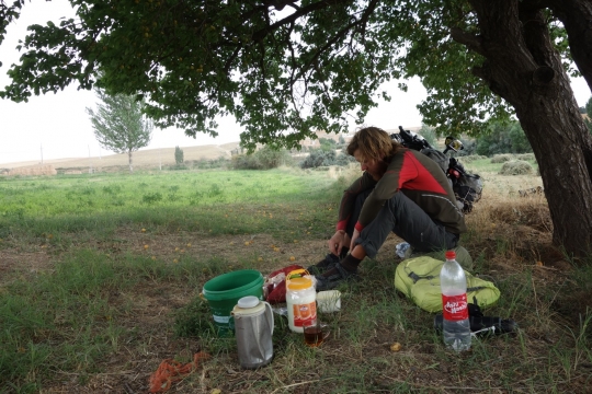 Tea, dough, bread, cheese and jam in a field