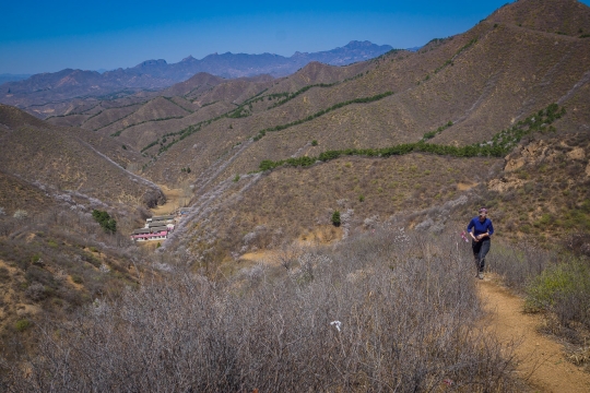On the section next to the wall to the valley